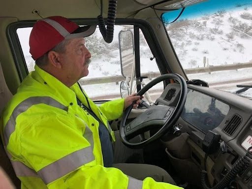 Driver in cab while trucking in snow